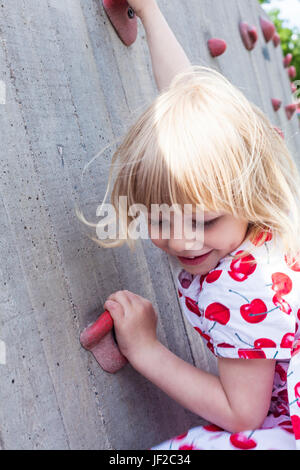 Mädchen, Klettern an der Kletterwand Stockfoto