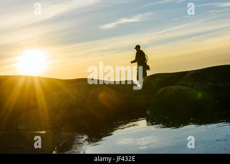 Silhouette der Mann Angeln Stockfoto