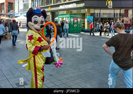Person gekleidet als Mickey Mouse Luftballons im Zentrum von Liverpool zu verkaufen Stockfoto