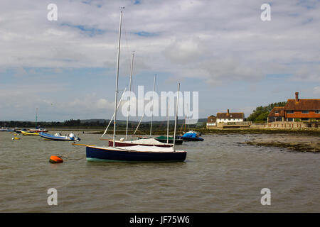 Sportboote auf ihren Liegeplätzen im historischen Hafen Bosham in West Sussex im Süden Englands Stockfoto