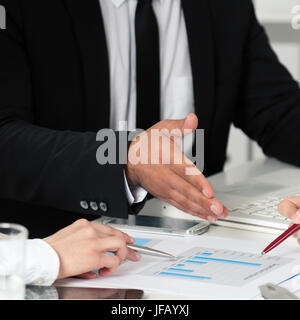 Geschäftsleute diskutieren, die Diagramme und Grafiken zeigen die Ergebnisse der ihre erfolgreiche Zusammenarbeit. Hände-Nahaufnahme Stockfoto