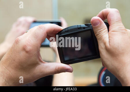 Menschen halten ihre Kameras fotografieren im Louvre. Stockfoto