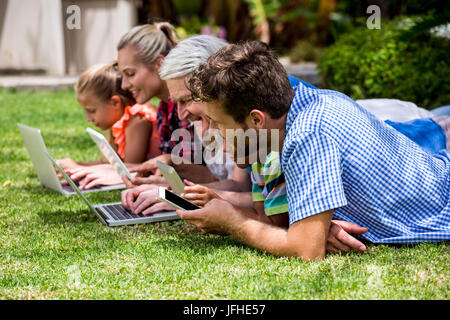 Familie mit Hilfe von Technologien und entspannen im park Stockfoto