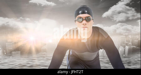 Zusammengesetztes Bild zuversichtlich Schwimmer im Neoprenanzug Stockfoto