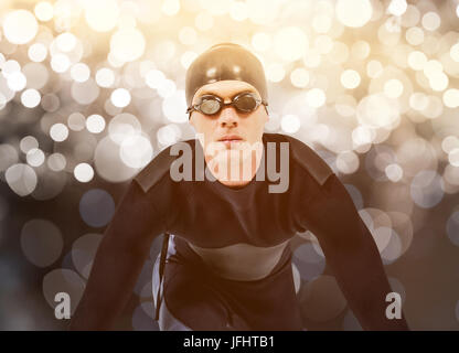 Zusammengesetztes Bild zuversichtlich Schwimmer im Neoprenanzug Stockfoto