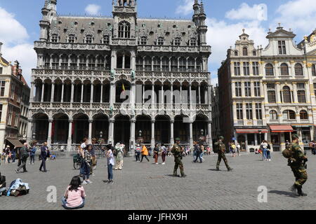 Bewaffnete Soldaten bewachen Le Grand Place in Brüssel mit der Maison du Roi, Haus des Königs, im Hintergrund. Stockfoto