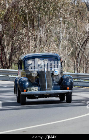 Jahrgang 1936 Oldsmobile FR Limousine fahren auf der Landstraße in der Nähe der Stadt Birdwood, South Australia. Stockfoto