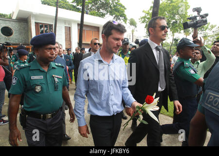 1. Juli 2017 - Dhaka, Bangladesch - Juli 01, 2017-Dhaka, Bangladesch '' "ein Beamter der italienischen Botschaft hält Blumen wie er Hinsicht mit Blumen vor dem neu errichteten Gebäude zahlt, wo die löchrigen Artisan Cafe früher in Gulshan in Dhaka, Bangladesch, 1. Juli 2017. Bangladesh A Terrorist Attack von Mitgliedern der lokalen Gruppe "militanten" Jamautul Mujahedin in einem beliebten Restaurant in Dhaka am 1. Juli 2016, links 20 Geiseln tot und mehrere verletzt. Militärischen Kommandos sechs bewaffneten getötet und 13 Geiseln gerettet, während des Angriffs. Dhaka Holey Restaurant wurde verlegt und am alten Standort wa Stockfoto