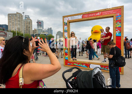 Toronto, Kanada. 1. Juli 2017. Menschen drängen sich die HTO Park, um Bilder und Selfies von der weltweit größten Rubber Duck während Redpath Waterfront Festival als Teil von Kanada 150 Feier statt. Dominic Chan/EXimages Stockfoto