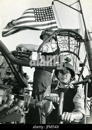 28. Juli 1943 - gehen die Sterne und Streifen Welle triumphierend als Trainer und Lader an Bord eines amerikanischen Cruiser methodisch über ihre Arbeit bei der Bombardierung die Invasion Siziliens begleitet. Stockfoto