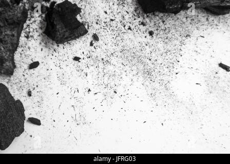Schwarze abstrakte strukturierte Komposition auf einem weißen Hintergrund, eine ausgewählte Fokus Nahaufnahme ein Haufen Würfel und Pulver von mineralischen Steinkohle. Stockfoto
