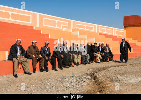 Traditionelle kurdische gekleidete Männer sitzen im Stadt Zentrum Al-Kosch für ihre Morgen Chat, Irak-Kurdistan Stockfoto