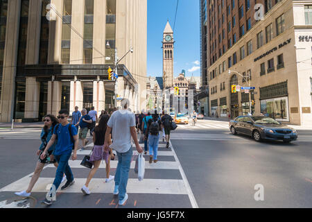 Toronto, CA - 24. Juni 2017: Menschen Kreuzung Querstraße Zebra an der Bay Street mit dem alten Rathaus im Hintergrund Stockfoto