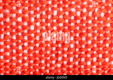 Eine gewebter Stoff Textur von ein Anfänger auf einem Webstuhl hergestellt, mit Orange-Garn vertikal horizontal verlaufende und weißem Garn. Stockfoto