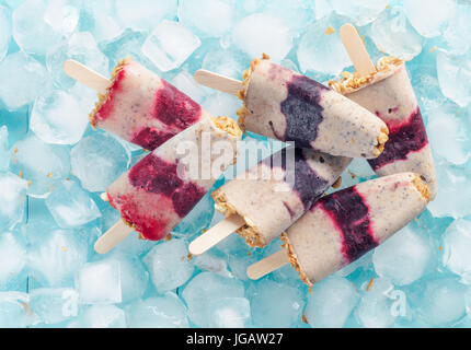 Eis am Stiel mit Früchten, Müsli und Chia Samen. Ansicht von oben Stockfoto