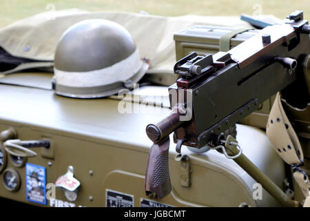 Sandhurst, Großbritannien - 18. Juni 2017: 1919 Browning Maschinengewehr montiert auf einem 1943 WW2 uns Armee Willys Jeep mit Helm im Hintergrund Stockfoto