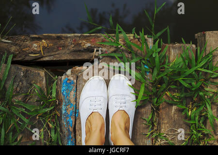 Nahaufnahme einer Frau die Füße stehen auf einer Holzbrücke Stockfoto