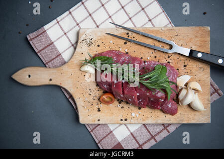 Draufsicht auf Steak mit Knoblauch und Kräutern Stockfoto