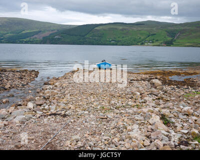 Kleines Boot gezogen auf einem felsigen Causeway am Ufer des Loch Broom in der Nähe von Ullapool, Highland, Schottland, UK. Stockfoto