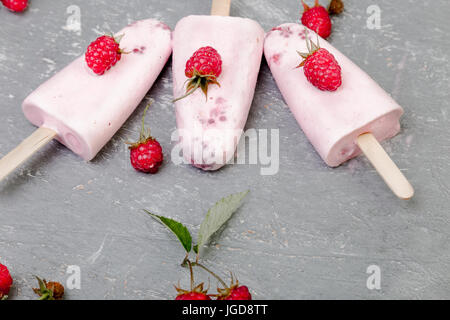 Himbeer Eis auf grauem Hintergrund. Drei Eis am Stiel. top anzeigen. Hausgemachte Stockfoto
