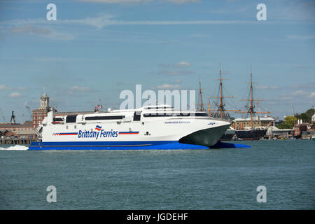 Brittany Ferries Katamaran Normandie Express vorbei HMS Krieger auf dem Weg aus Portsmouth Harbour. Stockfoto