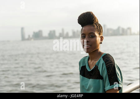 Porträt des afroamerikanischen Frau mit Zöpfen am Wasser Stockfoto