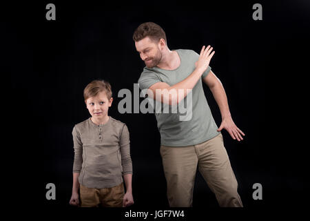 Wütend Vater bedroht und Gestikulieren, Angst kleiner Sohn, Familienprobleme Konzept Stockfoto