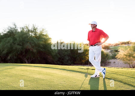 Hispanische Golfer wartet auf Golfplatz Stockfoto