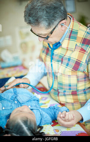 Hispanische Arzt hören Brust des Mädchens mit Stethoskop Stockfoto