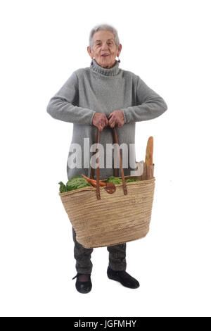 Alte Frau mit einem Korb mit einem Gewicht von viel Stockfoto