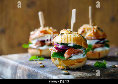 Ausgesät Brioche Brötchen mit heiß geräucherten Lachs, rote Beete und Rucola Stockfoto