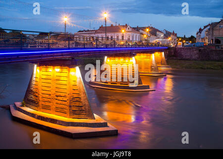 Beleuchtete Fußgängerbrücke in das Zentrum von Uzhgorod am Abend, Ukraine Stockfoto