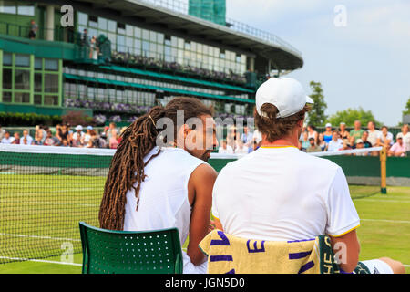Deutsche Tennisspieler Dustin Brown und Mischa Zverev sprechen Taktik während ein Herren Doppel-Match in Wimbledon Tennis Weltmeisterschaften 2017, ganz England Stockfoto