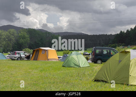 Camping Zelte auf dem grünen Sommerwiese mit bewölktem Himmel Stockfoto