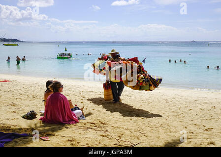 Pamplemousses, Mauritius - 4. Januar 2017. Anbieter mit Souvenirs am Strand im sonnigen Tag in Trou Aux Biches, Mauritius. Der Strand ist einer der meisten bea Stockfoto