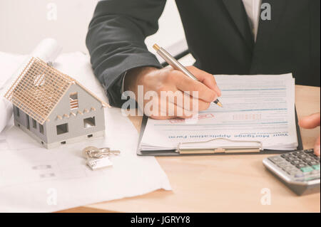 Ein Geschäftsmann eine Hypothek Unterzeichnung Kaufvertrag für ein neues Haus Stockfoto