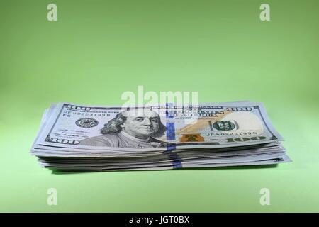 Stapel von neuen hundert-Dollar-Rechnungen amerikanischen 100 USD Bargeld auf grünem Hintergrund Stockfoto