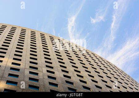Niedrigen Winkel Blick auf die konkrete Fassade eines Bürogebäudes mit blauem Himmel. Stockfoto