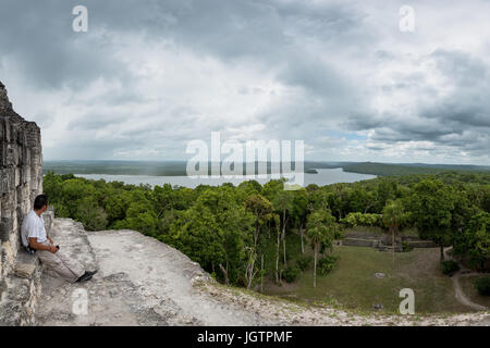 Ein Mann, genießen die Aussicht von der Spitze der Tempel IV, Tikal, El Petén, Guatemala. Stockfoto