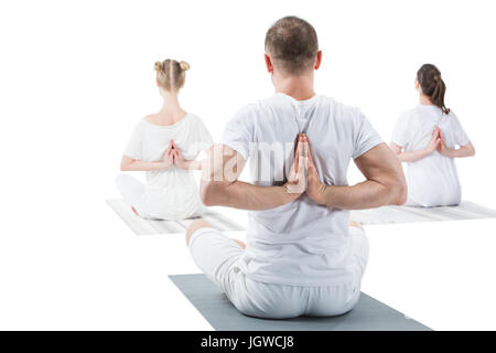 Rückansicht des sportlichen jungen Menschen sitzen im Lotussitz mit Mudra namaste Stockfoto