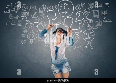 Shocked woman holding laptop over head Stockfoto