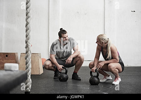 Paar mit Kettlebells in cross-training Fitness-Studio Stockfoto
