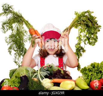 glückliches kleine Mädchen Kochen mit Karotten und Gemüse Stockfoto