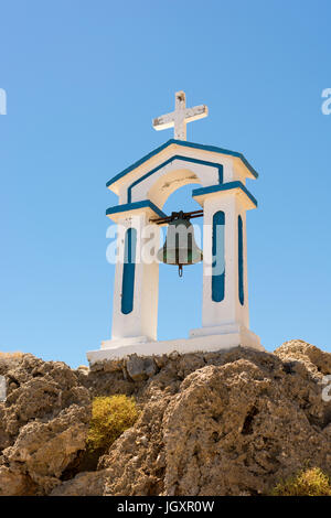 Entfernten, kleinen, weißen griechischen Kirche auf Felsen direkt am Meer an der Südküste von Kreta, Westgriechenland, mit einem separaten Glockenturm gebaut. Stockfoto