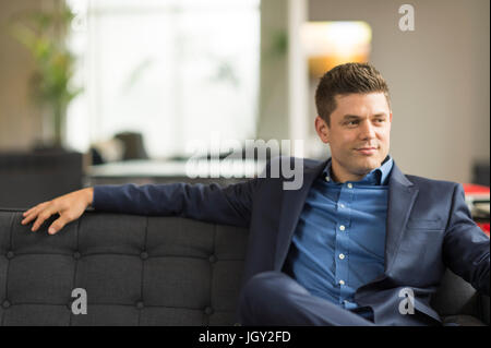 Porträt von zuversichtlich Geschäftsmann auf Büro Sofa sitzen Stockfoto