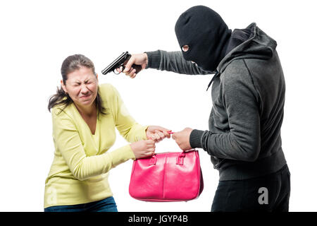 Eine gefährliche bewaffnete Räuber stiehlt eine Tasche von einer Frau Stockfoto