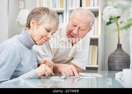 Senioren tun Haushalt Buchhaltung mit Taschenrechner und Planung Stockfoto