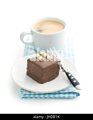 Süße Schokolade Dessert auf Dessertteller mit Dessertgabel und Kaffeetasse isoliert auf weißem Hintergrund. Stockfoto