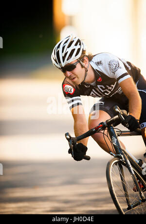 Ein sportlicher Junge männliche Radfahrer konkurriert in einem urbanen Straßenrennen. Stockfoto