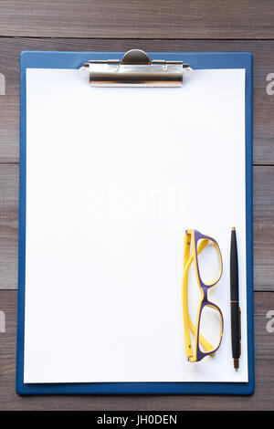 leeren Blatt Papier für Notizen auf einem Tisch mit Brille und Stift beiseite. Draufsicht von oben Stockfoto